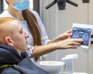 young-female-dentist-showing-patient-dental-xray-dentistry-concept_169016-669731